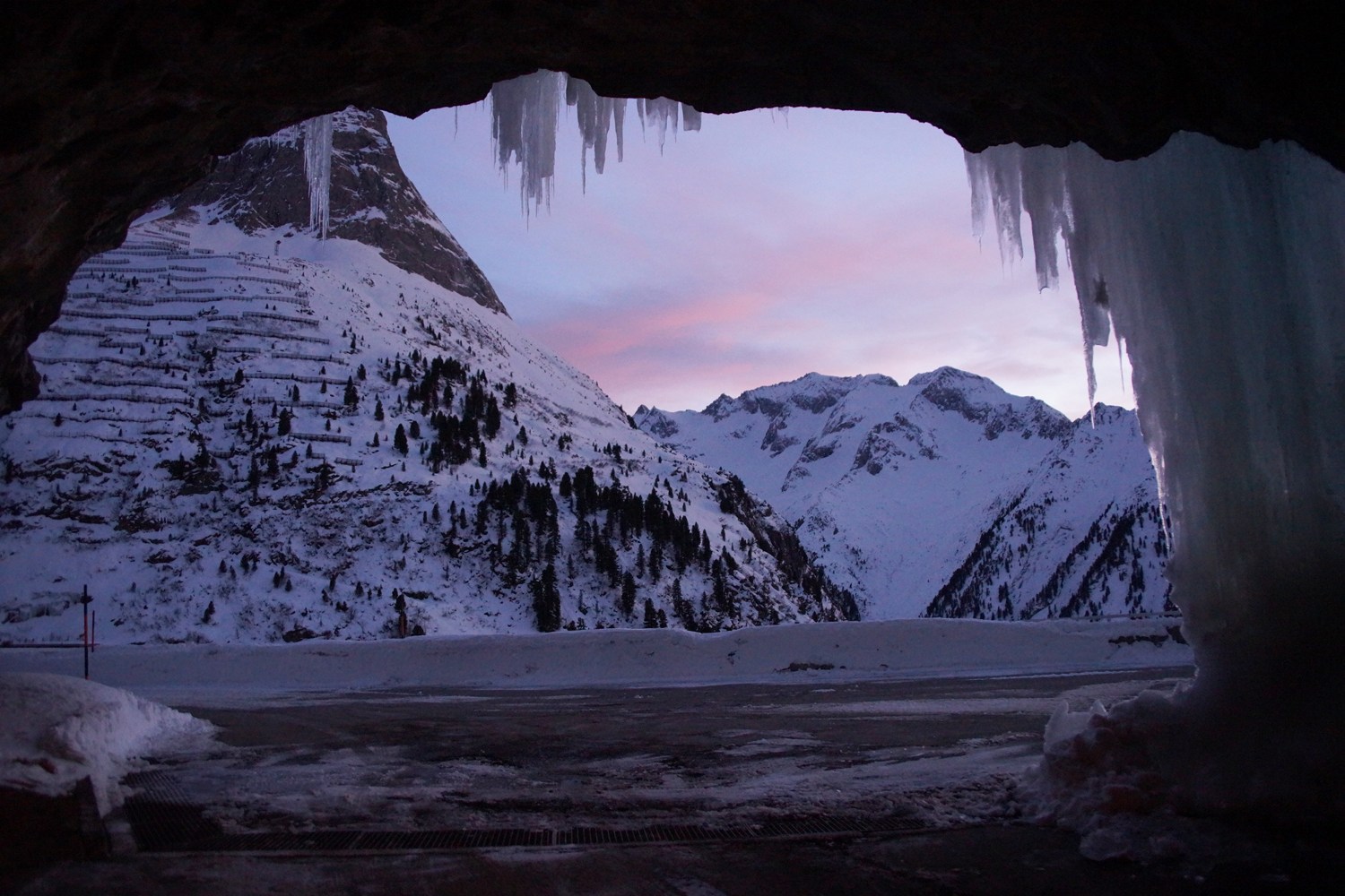 Mountain view framed by ice at dusk