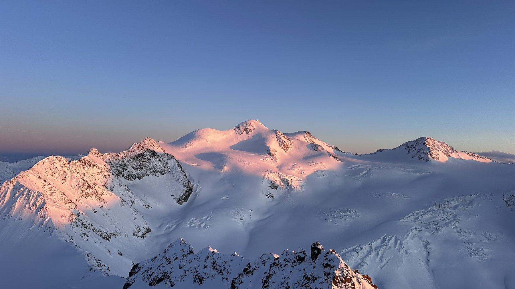 Sunrise lighting the snowy mountain peaks